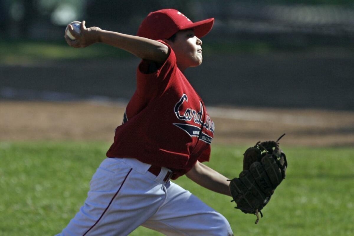 Burbank Cardinals' Jorge Gutierrez makes a pitch in a 7-1 win over Montrose Travel.