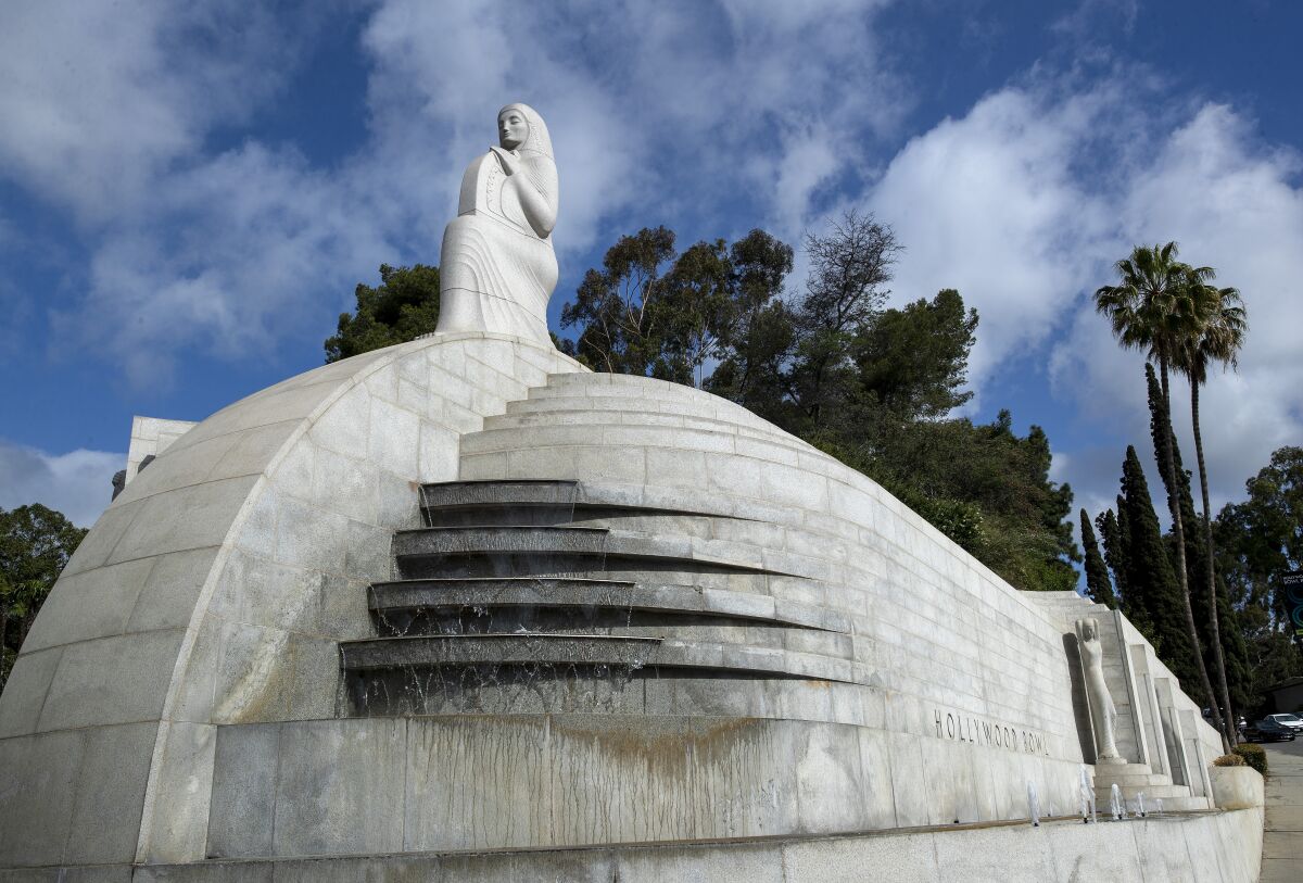  The Art Deco "Muse of Music, Dance, Drama" sculpture against a blue sky