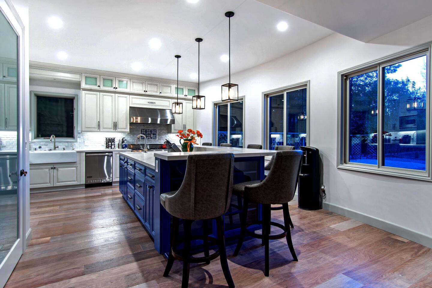 There's seating for six around the bright blue kitchen island.