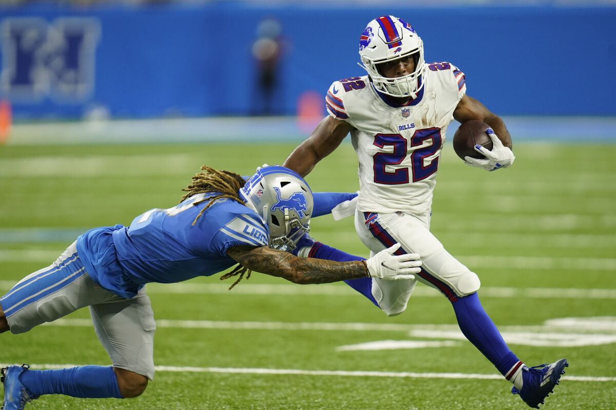 Detroit Lions defensive back Mike Ford attempts a tackle on Buffalo Bills running back Matt Breida (22) during the first half of a preseason NFL football game, Friday, Aug. 13, 2021, in Detroit. (AP Photo/Paul Sancya)