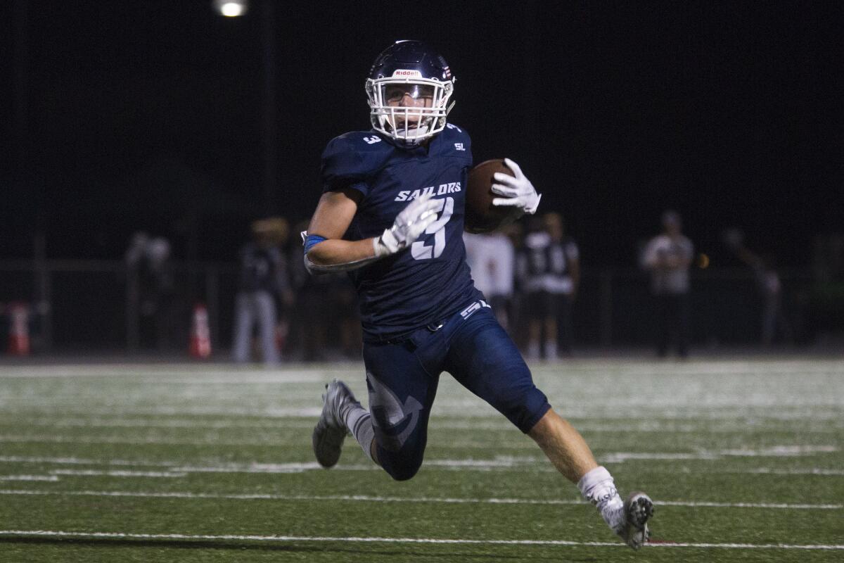 Newport Harbor's Justin McCoy, shown running the ball against Santa Monica on Sept. 20, had the game-winning touchdown run in the Sailors' 24-20 upset of Monrovia in the CIF Southern Section Division 9 quarterfinals on Nov. 15.