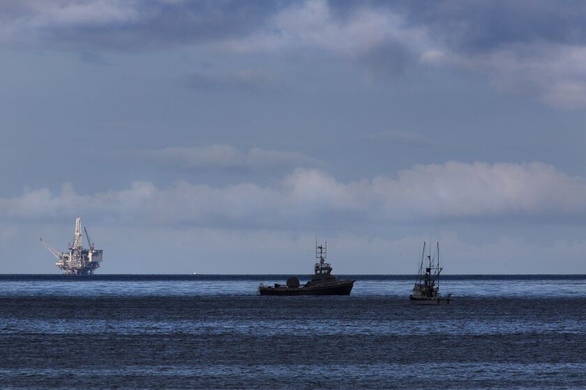 Oil recovery and cleanup vessels ply the waters off of El Capitan State Beach near Santa Barbara on May 21, 2015. An oil drilling rig in the Santa Barbara Channel is on the horizon, left.