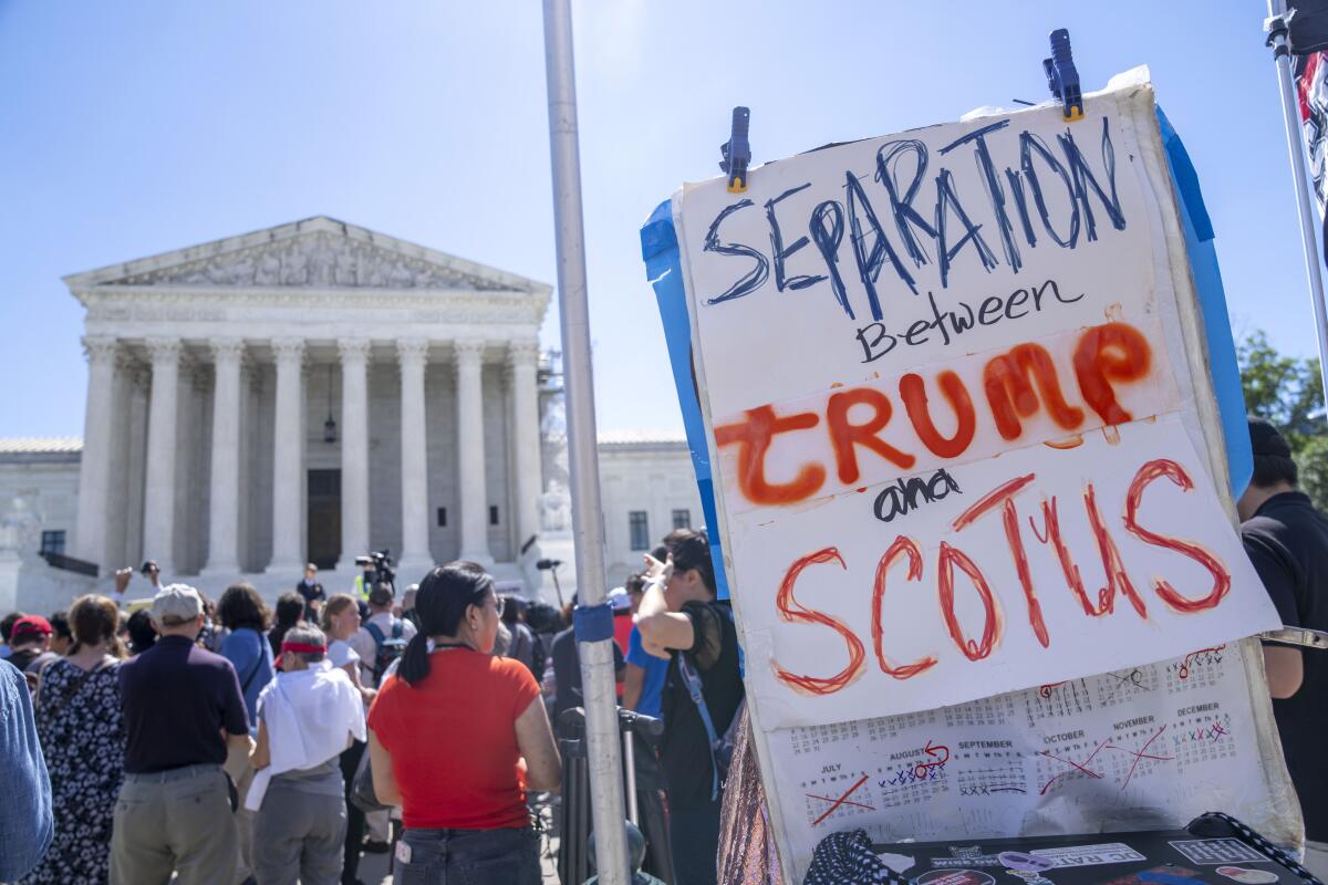 A protest outside the Supreme Court features a sign reading "Separation between Trump and SCOTUS."