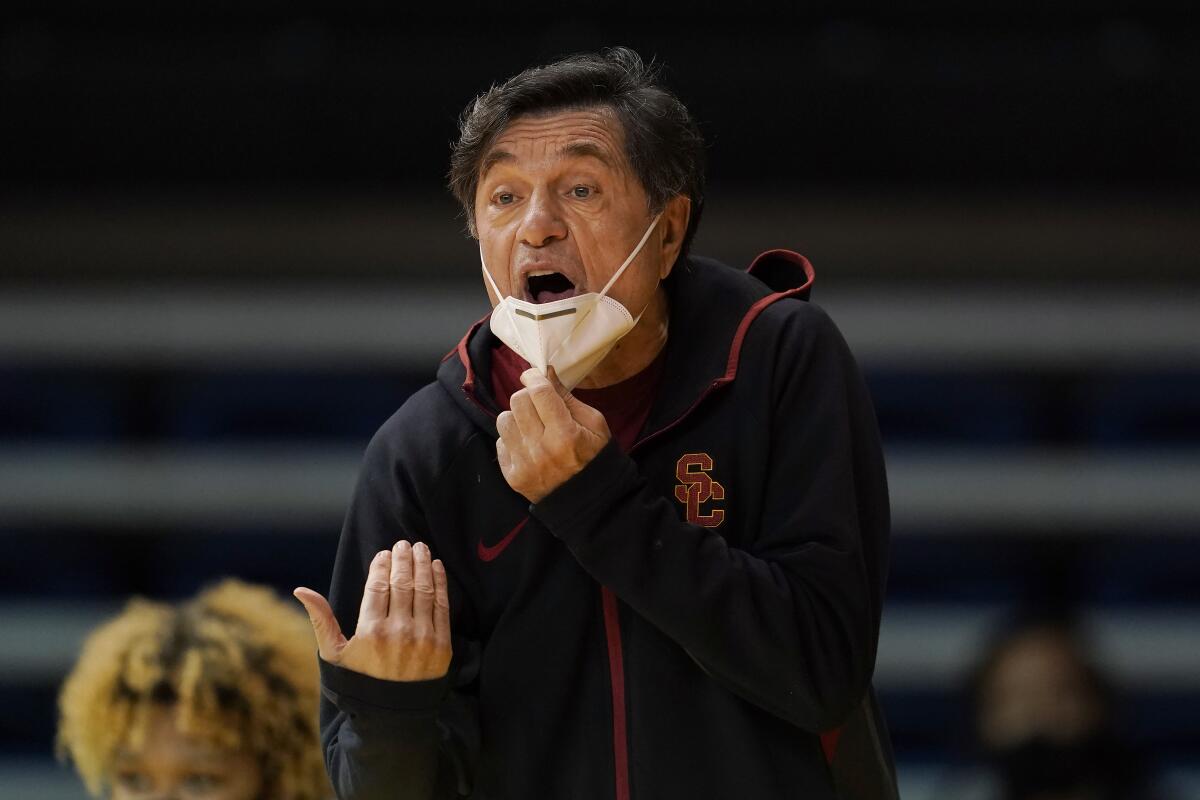 USC head coach Mark Trakh gestures toward players.