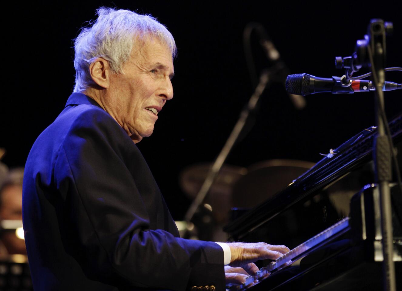 Burt Bacharach onstage playing the piano