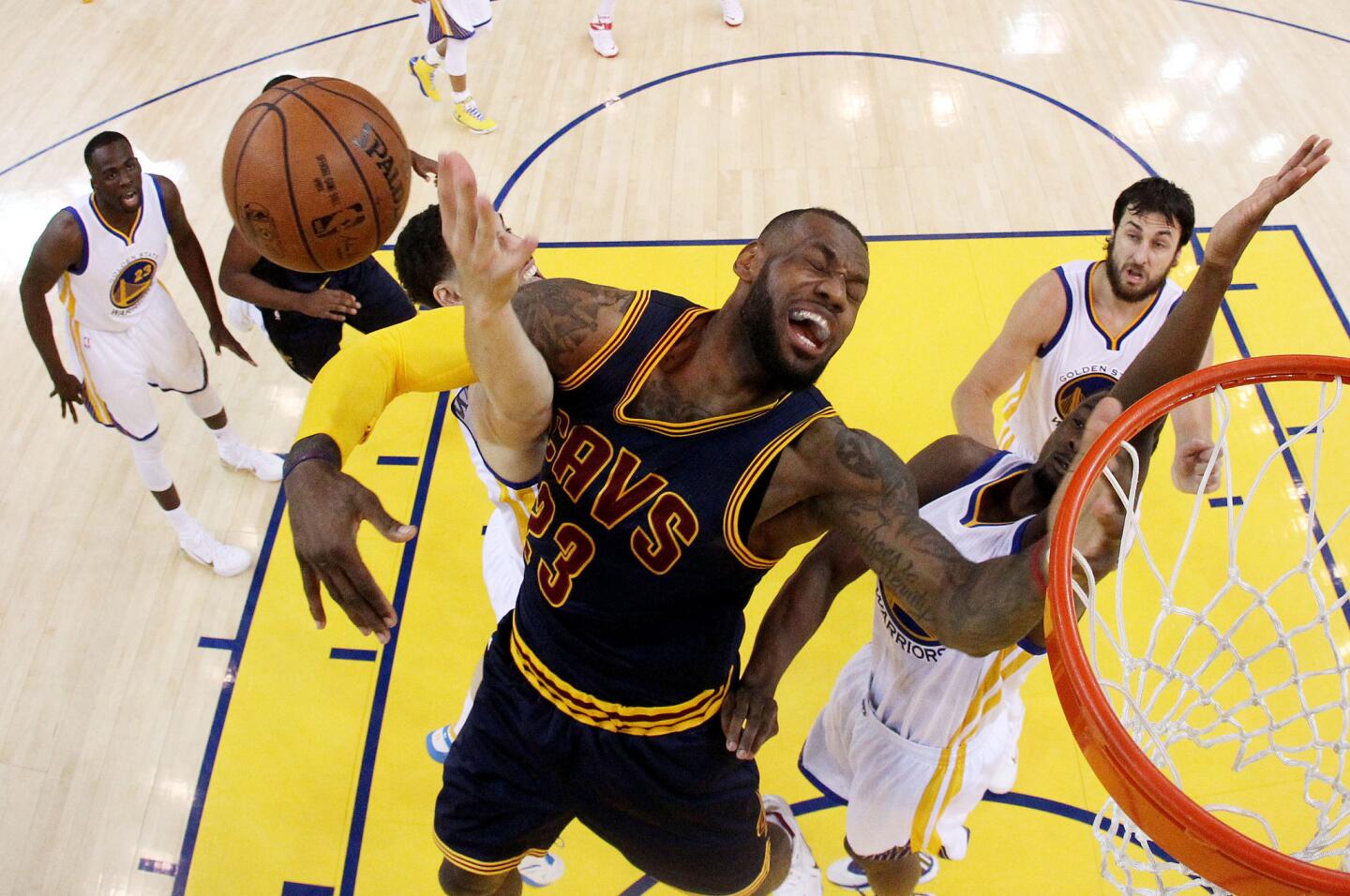 Cavaliers forward LeBron James gets tangled with Warriors guard Klay Thompson in the first half of Game 1 on Thursday night in Oakland.