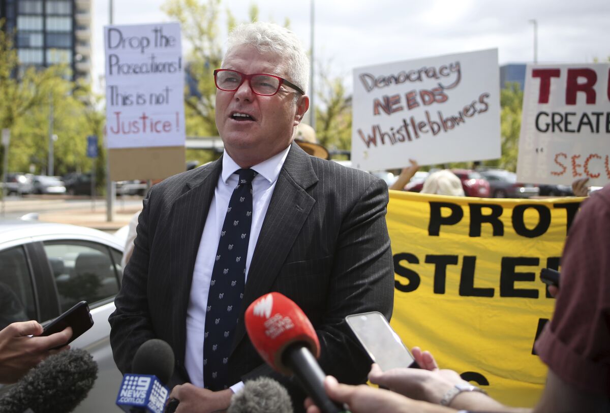 Defendant David McBride talks to the media before his court appearance in Canberra, Australia, on Friday, Feb. 14, 2020. His lawyer Bernard Collaery is charged with conspiring to reveal classified information that expose a diplomatic scandal and McBride is charged with leaking secret documents alleging military misconduct in Afghanistan. (AP Photo/Rod McGuirk)