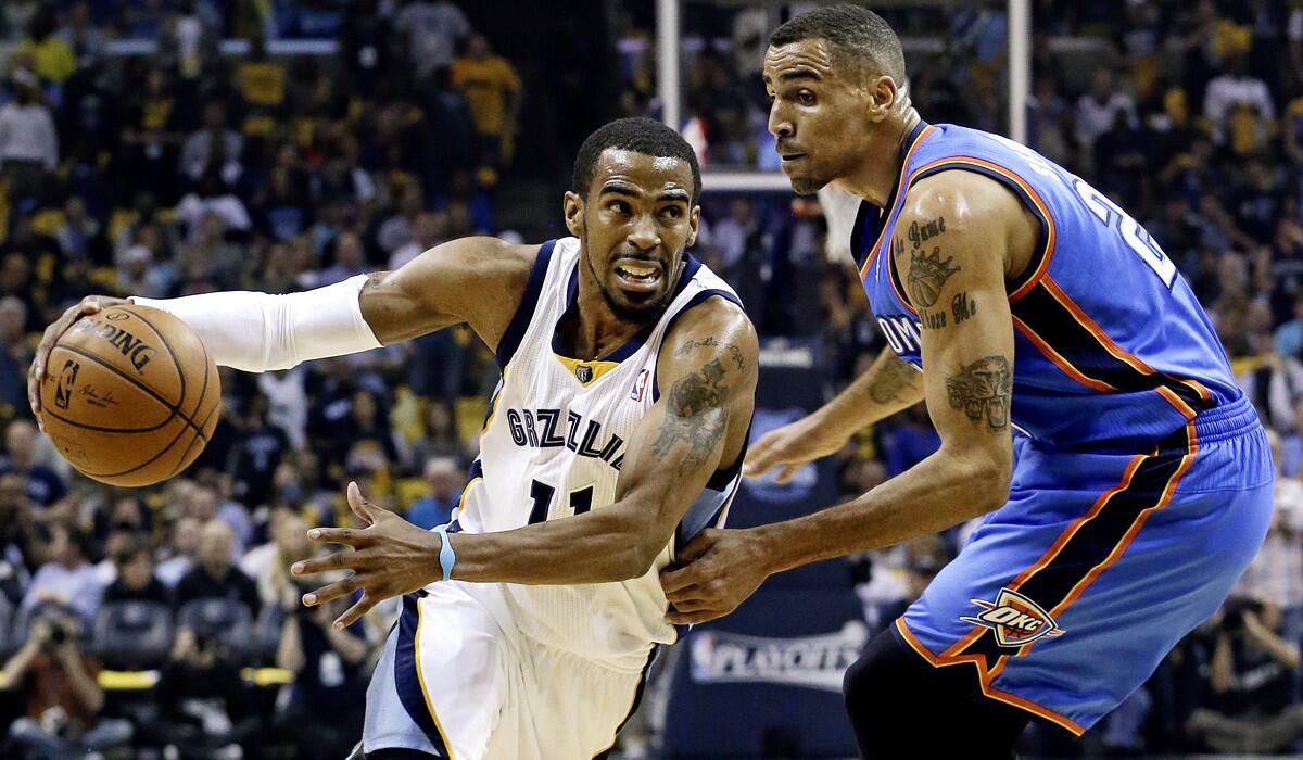 Grizzlies point guard Mike Conley, who finished with a team-high 20 points, drives past Thunder guard Thabo Sefolosha in the first half Thursday night in Memphis.