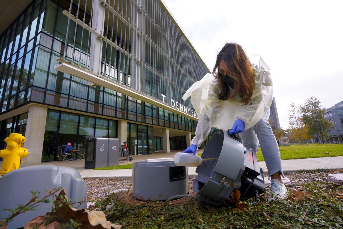 Postdoctoral researcher, Smruthi Karthikeyan gathers a waste sample.