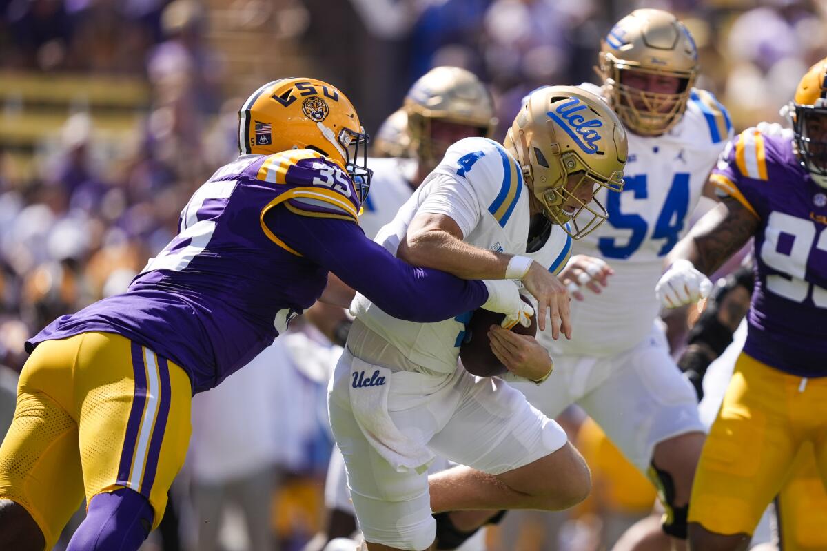 UCLA quarterback Ethan Garbers is sacked by LSU defensive end Sai'vion Jones.