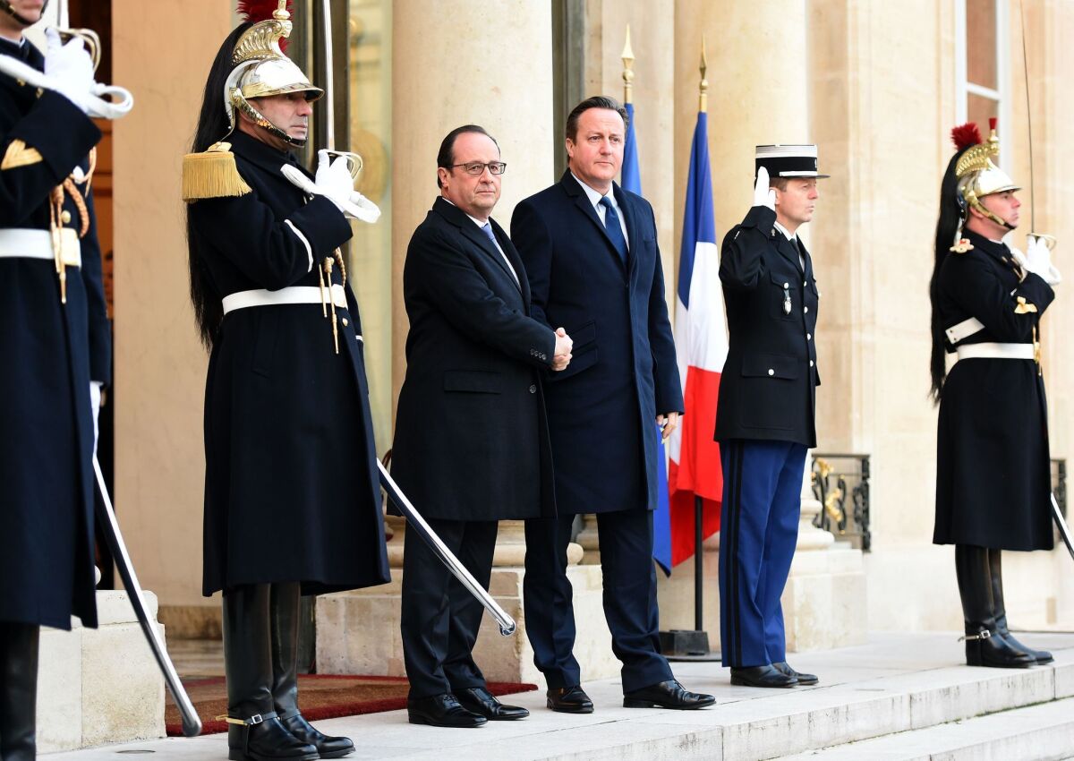French President Francois Hollande shakes hands with British Prime Minister David Cameron at the Elysee Palace in Paris on Nov. 23.