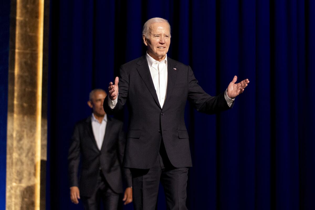 President Biden with former President Obama in the background