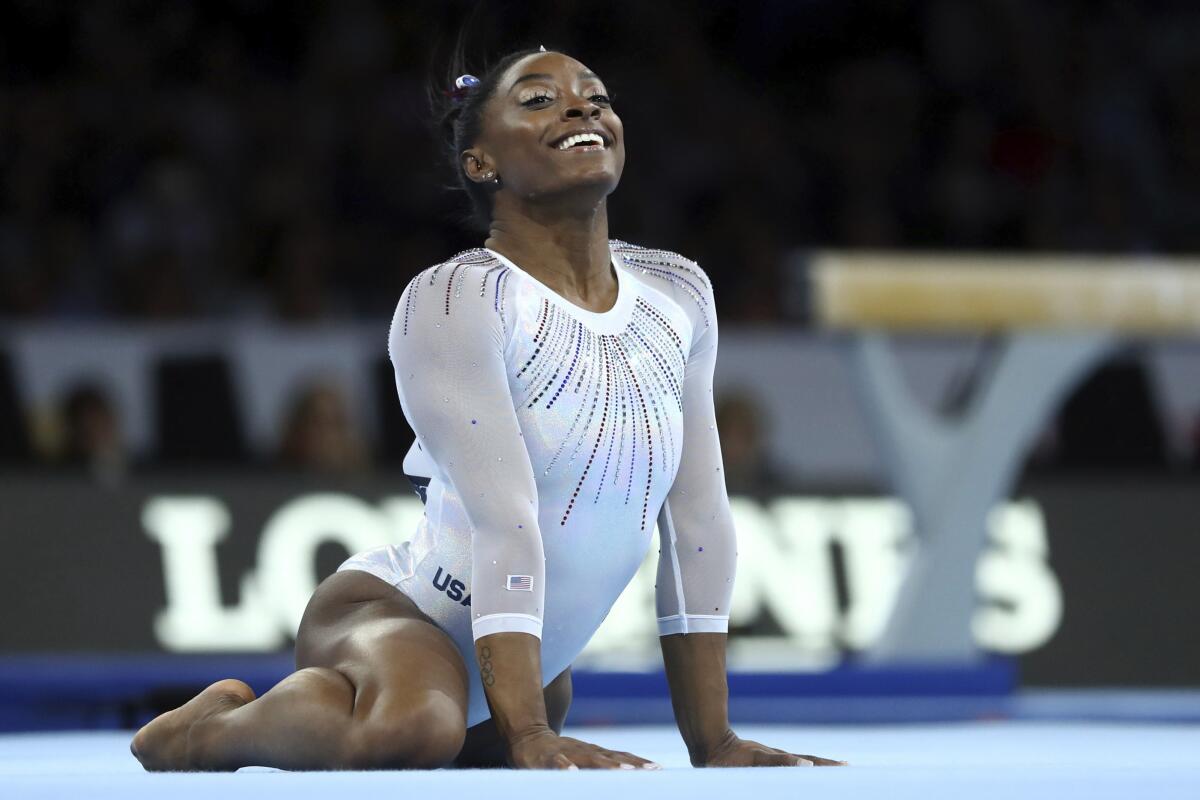 Simone Biles won her fifth all-around world gymnastics title Thursday in Stuttgart, Germany.