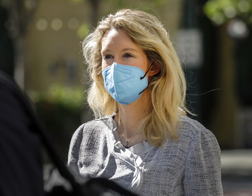 FILE - Elizabeth Holmes, founder and CEO of Theranos, left, leaves the Robert F. Peckham Federal Building in downtown San Jose, Calif., on Tuesday, May 4, 2021. The U.S. government rested its case in the trial of fallen Silicon Valley star Elizabeth Holmes on Friday, Nov 19, after spending more than two months trying to prove she bamboozled investors, patients and business partners into believing that her startup Theranos was about to reshape health care by using just a few drops for blood for tests that usually require vials of the stuff.(Nhat V. Meyer/Bay Area News Group via AP, File)