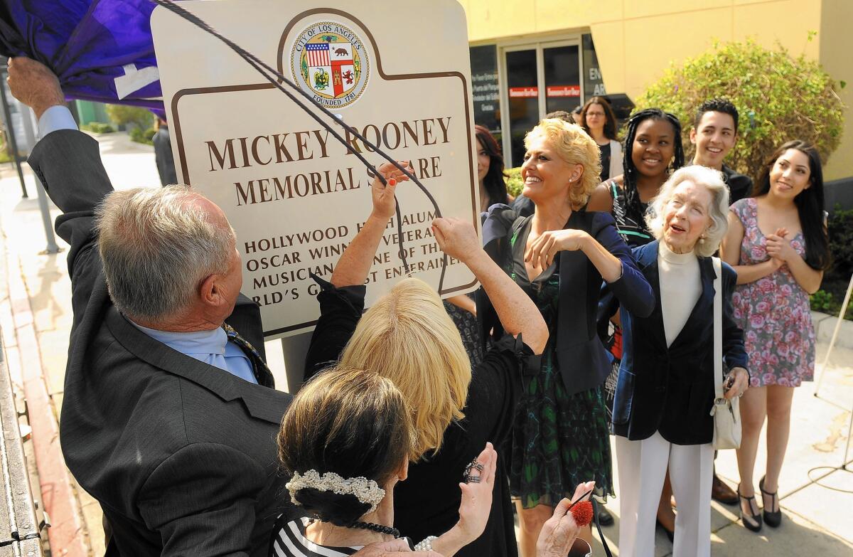 L.A. City Councilman Tom LaBonge helps reveal Mickey Rooney Memorial Square at the intersection of Sunset Boulevard and Orange Drive in Hollywood surrounded by the late actor's family and friends.