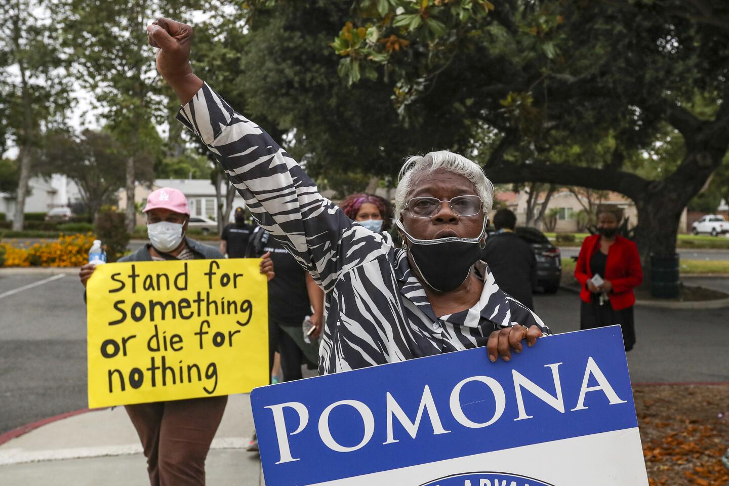 Jeanette Ellis-Royston, president of the NAACP Pomona Valley, raises a fist during the Juneteenth march in Pomona
