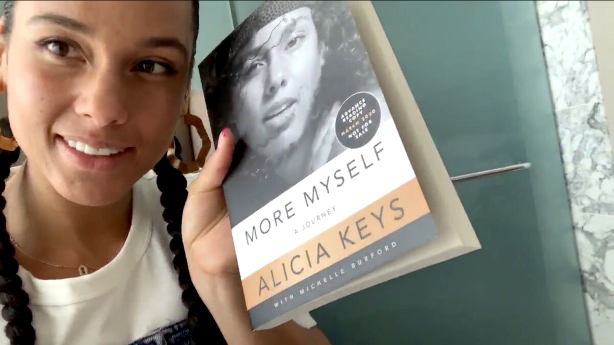Alicia Keys holds a copy of her book, "More Myself."