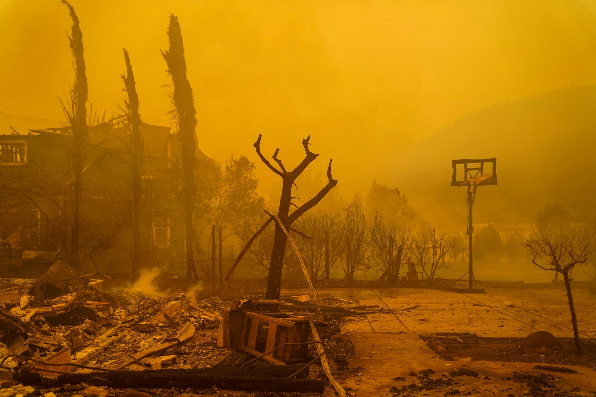 Orange smoke envelopes homes and rubble in Santa Rosa.