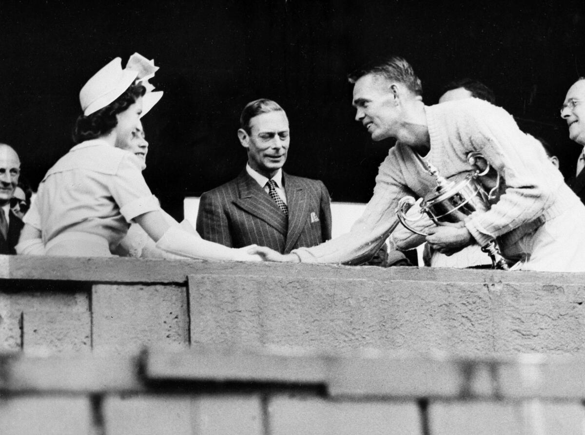 Jack Kramer, right, shakes hands with Princess Margaret Rose after winning at Wimbledon.