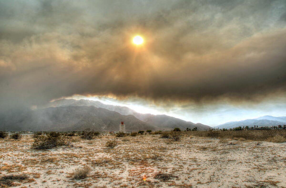 Smoke from a brush fire Monday near Mountain Center obscures the sky above the Palm Springs airport.