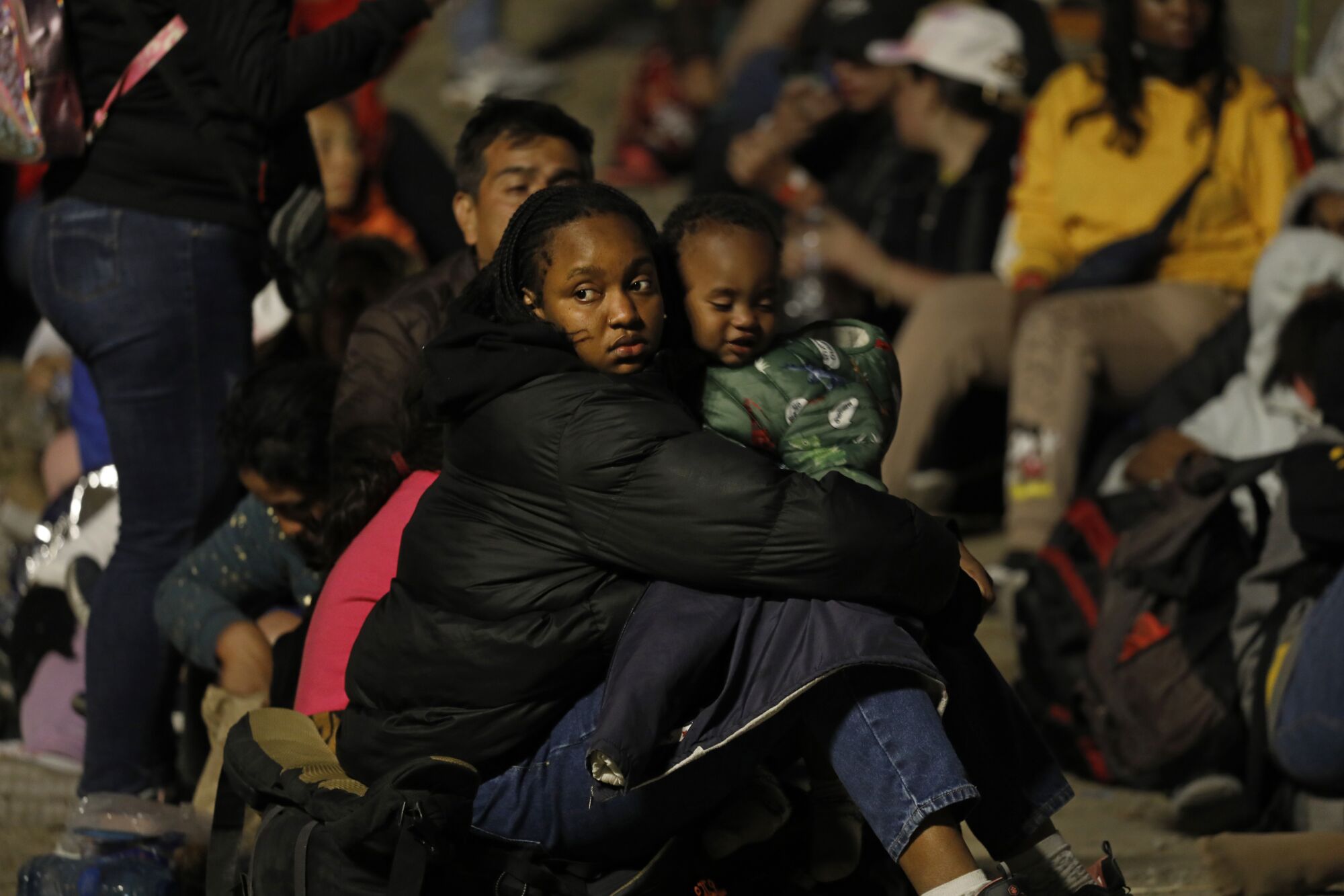 Migrants hoping to cross to the United States from Tijuana wait in an area north of the city.