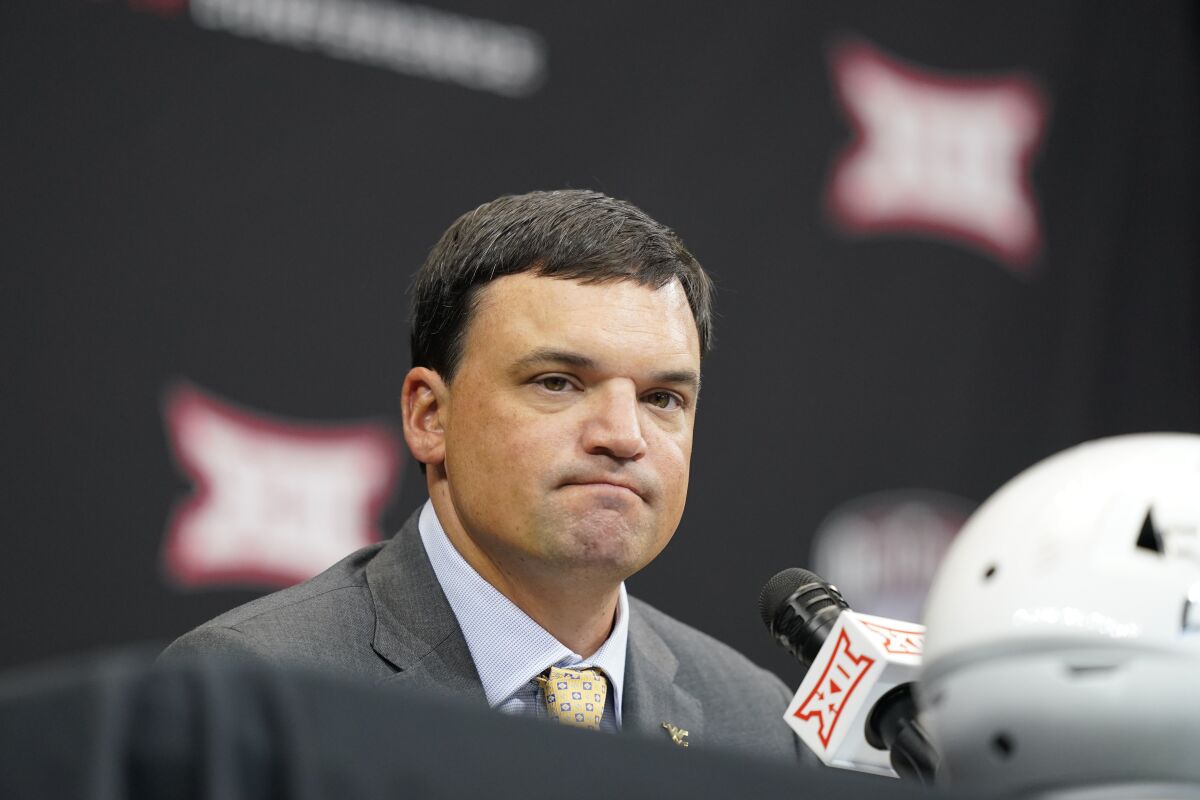 FILE - West Virginia head coach Neal Brown listens to a reporter's question at the NCAA college football Big 12 media days in Arlington, Texas, Wednesday, July 13, 2022. Brown is 17-18 with one winning season and has finished no better than a tie for fifth in the Big 12, so this could be a pivotal year for his job security. (AP Photo/LM Otero, File)
