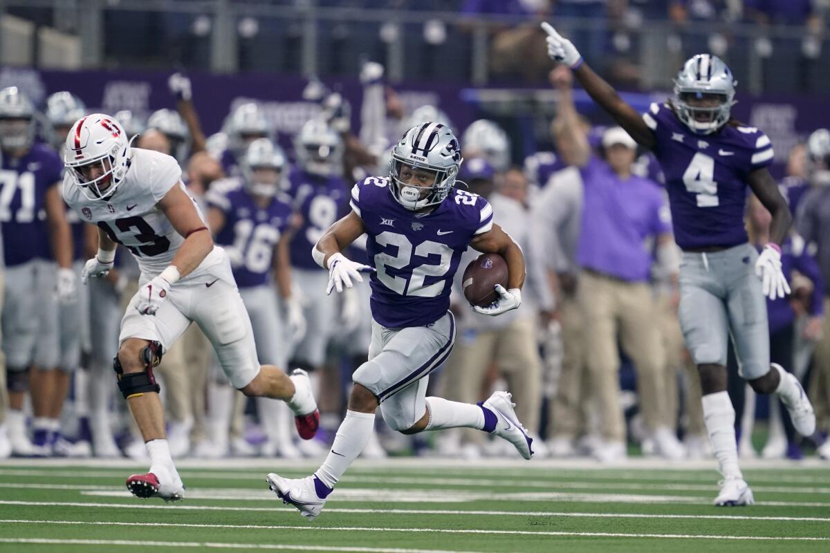 Kansas State running back Deuce Vaughn (22) is cheered on by wide receiver Malik Knowles (4) as Vaughn sprints past Stanford cornerback Ethan Bonner (13) on his way to the end zone for a touchdown in the first half of an NCAA college football game in Arlington, Texas, Saturday, Sept. 4, 2021. (AP Photo/Tony Gutierrez)