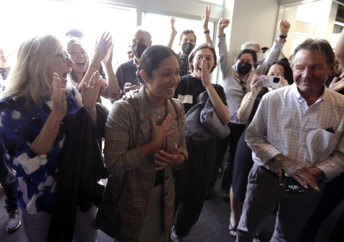 Times Photographer Christina House is applauded by newsroom staff after winning the Pulitzer Prize for Feature Photography.