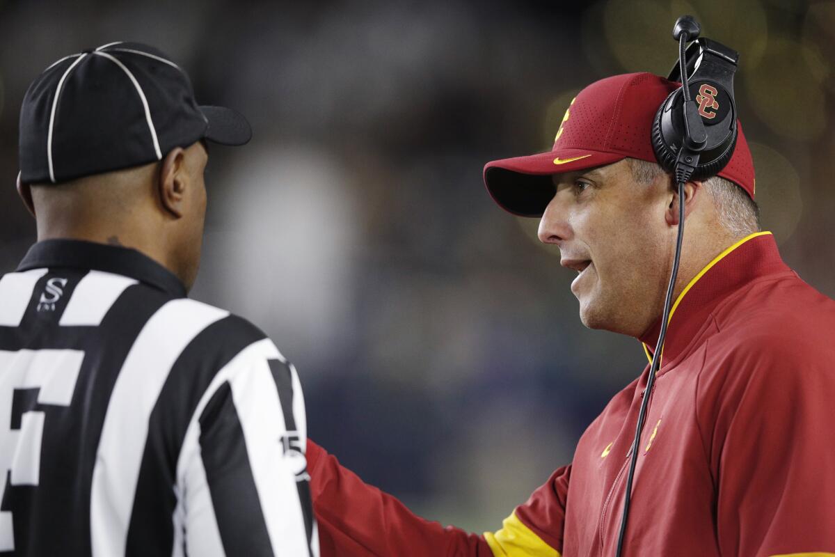 USC coach Clay Helton talks with an official during the Trojans' 30-27 loss at No. 9 Notre Dame.