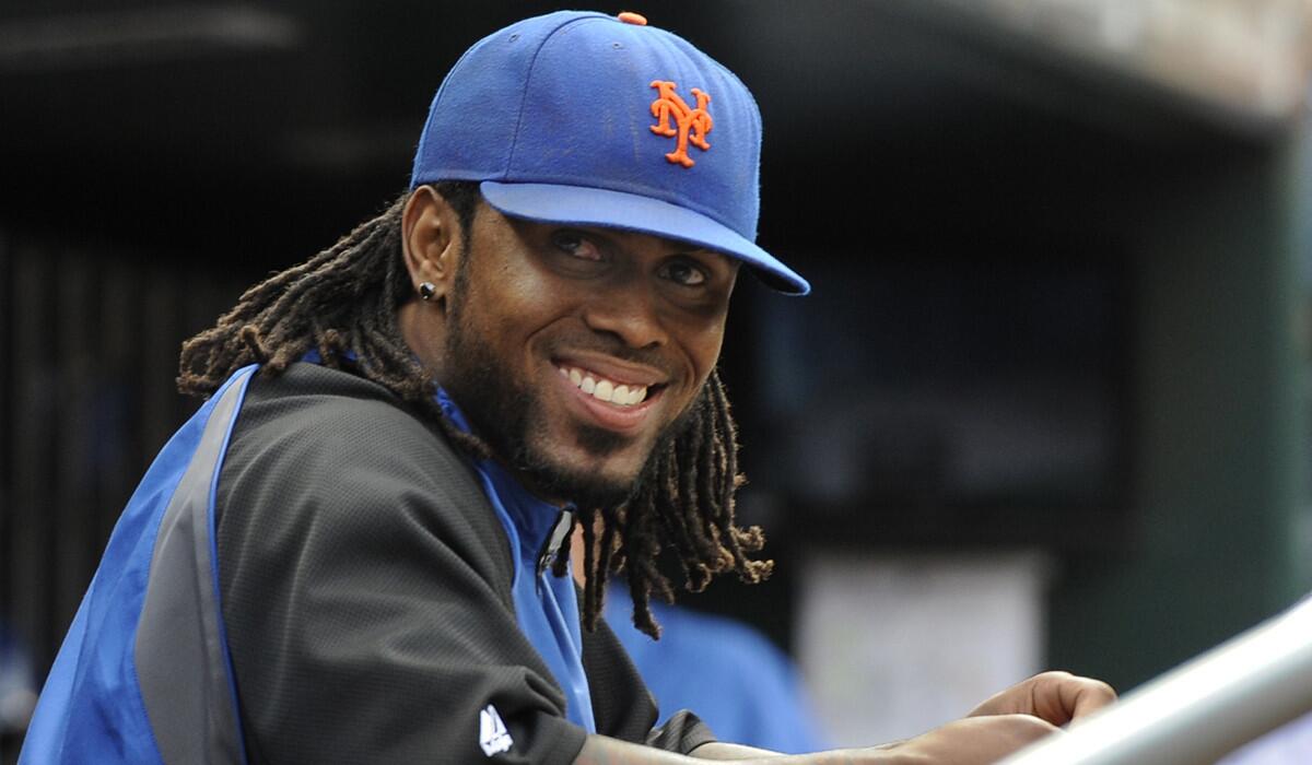 New York Mets' Jose Reyes smiles in the dugout in the ninth inning against the Cincinnati Reds in September 2011. The Mets have signed Reyes to a minor league contract on Saturday.