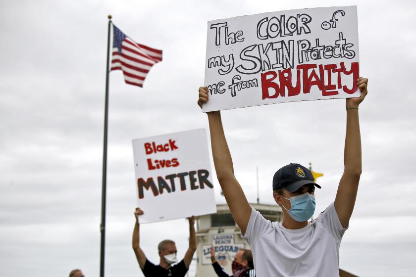 Dozens of Black Lives Matter/George Floyd protesters like 19-yr. old Laguna Beach resident Alexander Kvitsinski held signs and chanted at Main Beach Park in Laguna Beach on Friday, June 5, 2020.