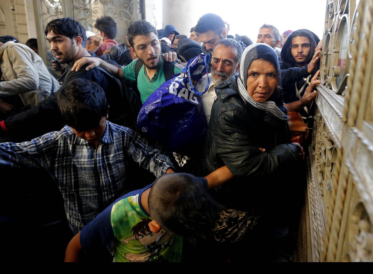 Migrants enter the main railway station in Budapest on Sept. 3.