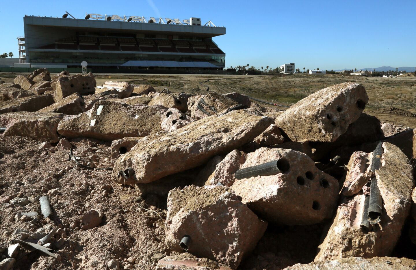 Chunks of concrete will eventually be crushed and later used as roadbed at the former Hollywood Park site in Inglewood where an NFL stadium will eventually be constructed.