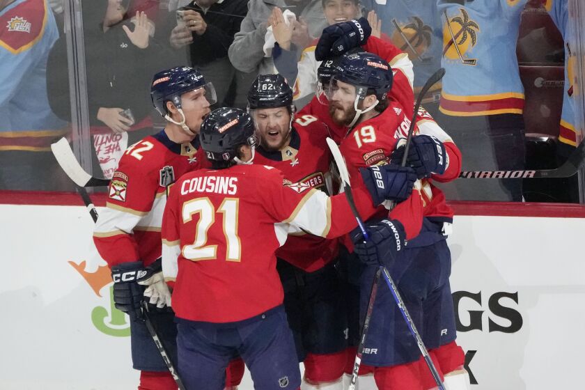 Florida Panthers defenseman Brandon Montour (62), center, is congratulated by his teammates after scoring goal during the first period of Game 3 of the NHL hockey Stanley Cup Finals against the Vegas Golden Knights, Thursday, June 8, 2023, in Sunrise, Fla. (AP Photo/Rebecca Blackwell)