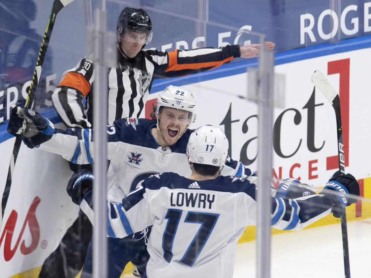 Adam Lowry breaks 3rd-period tie, Jets beat Maple Leafs 5-2 - The San Diego  Union-Tribune