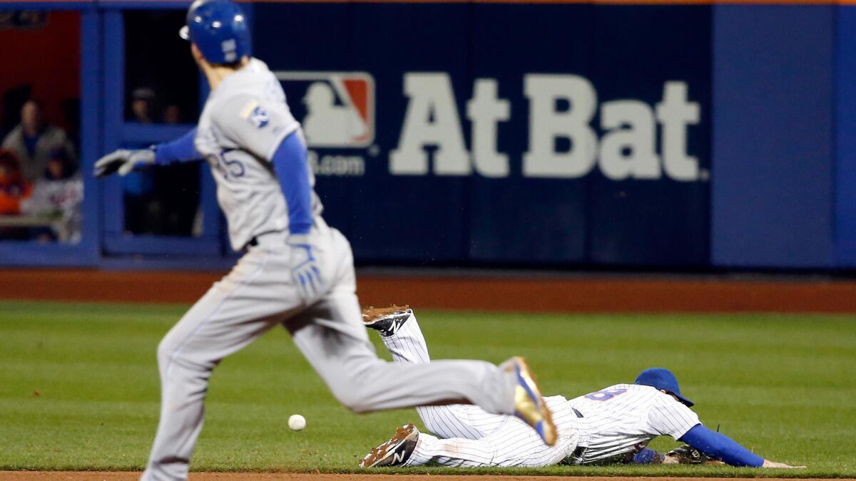 Mets second baseman Daniel Murphy falls as he tries to chase down a ground ball he misplayed in the eighth inning of Game 4 on Saturday night.