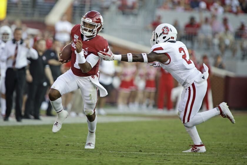 NORMAN, OK - SEPTEMBER 07: Quarterback Jalen Hurts #1 of the Oklahoma Sooners slips past safety Mike Johnson #2 of the South Dakota Coyotes at Gaylord Family Oklahoma Memorial Stadium on September 7, 2019 in Norman, Oklahoma. The Sooners defeated the Coyotes 70-14. (Photo by Brett Deering\Getty Images)