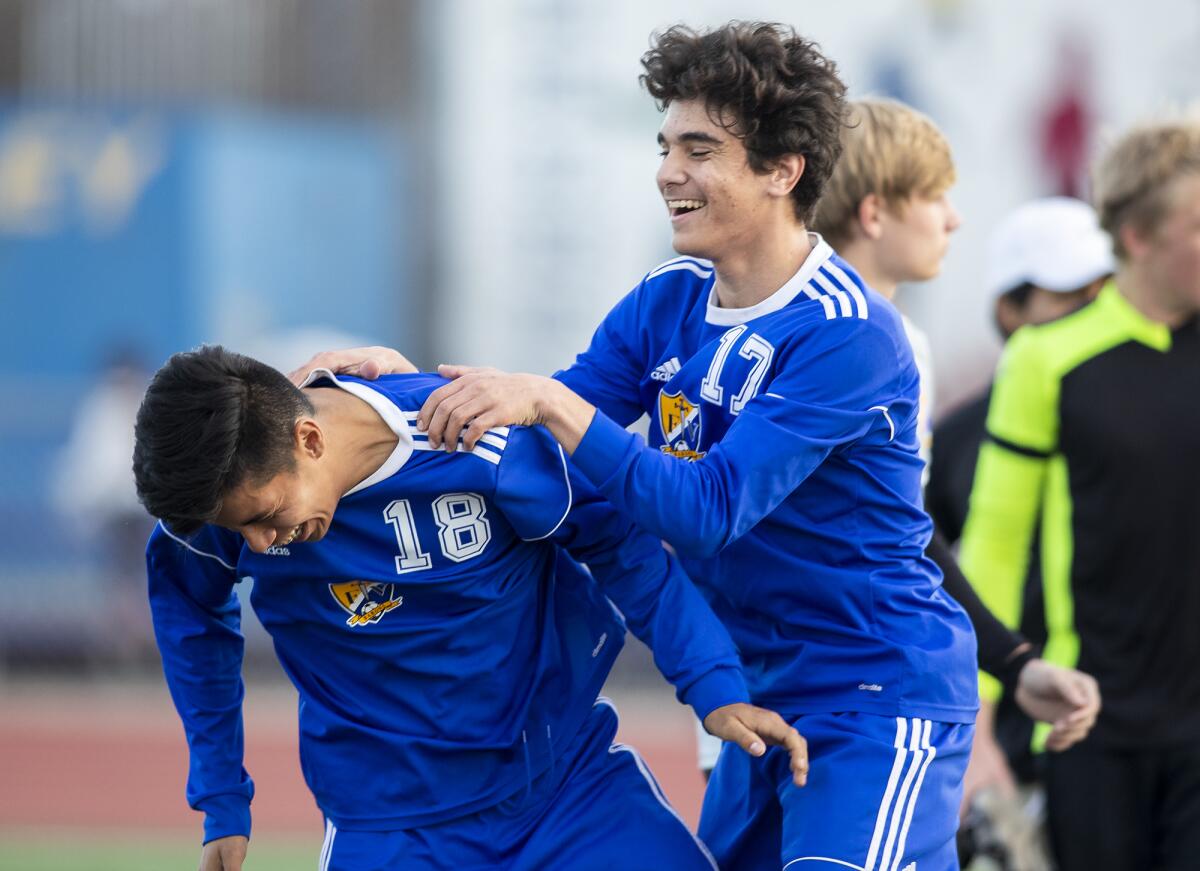 Fountain Valley's Vladimir Tobon, left, and Omar Shukairy celebrate after beating Huntington Beach 2-1 in a Wave League match on Wednesday.