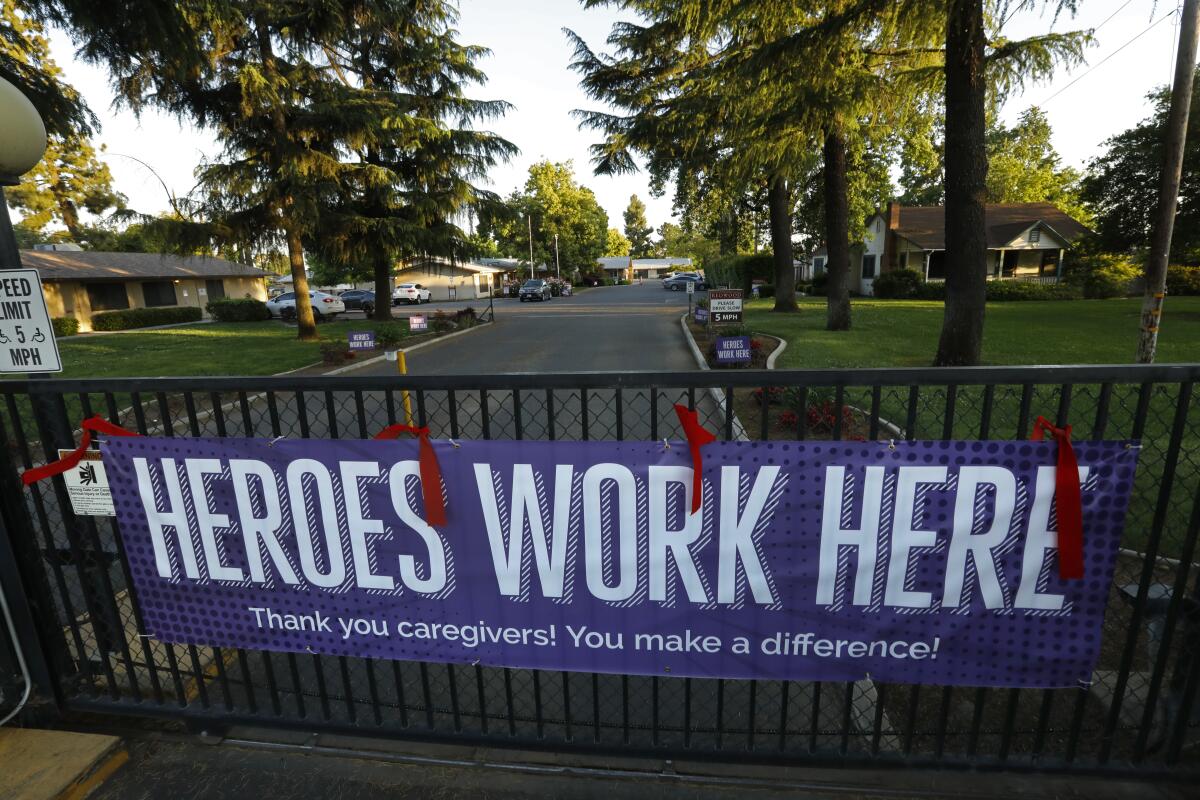 A banner hangs outside a nursing home in Visalia.