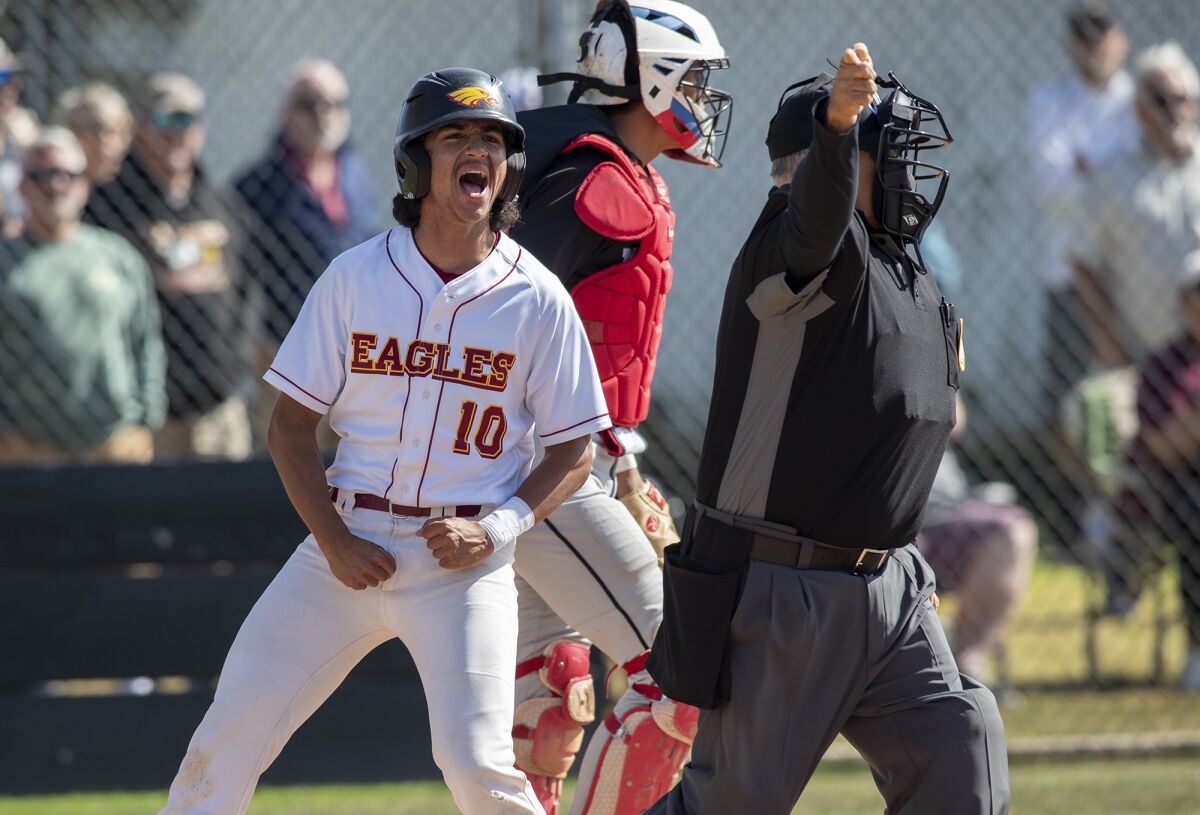 Estancia's James De La O celebrates after scoring on a double by Blake Peck in the second round of the Division 6 playoffs.