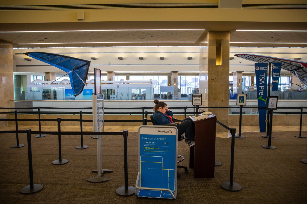 A TSA agent in an empty John Wayne Airport