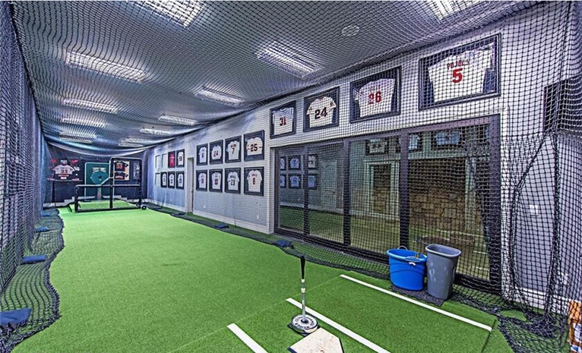 The home features a movie theater, wine cellar, game room and indoor batting cage