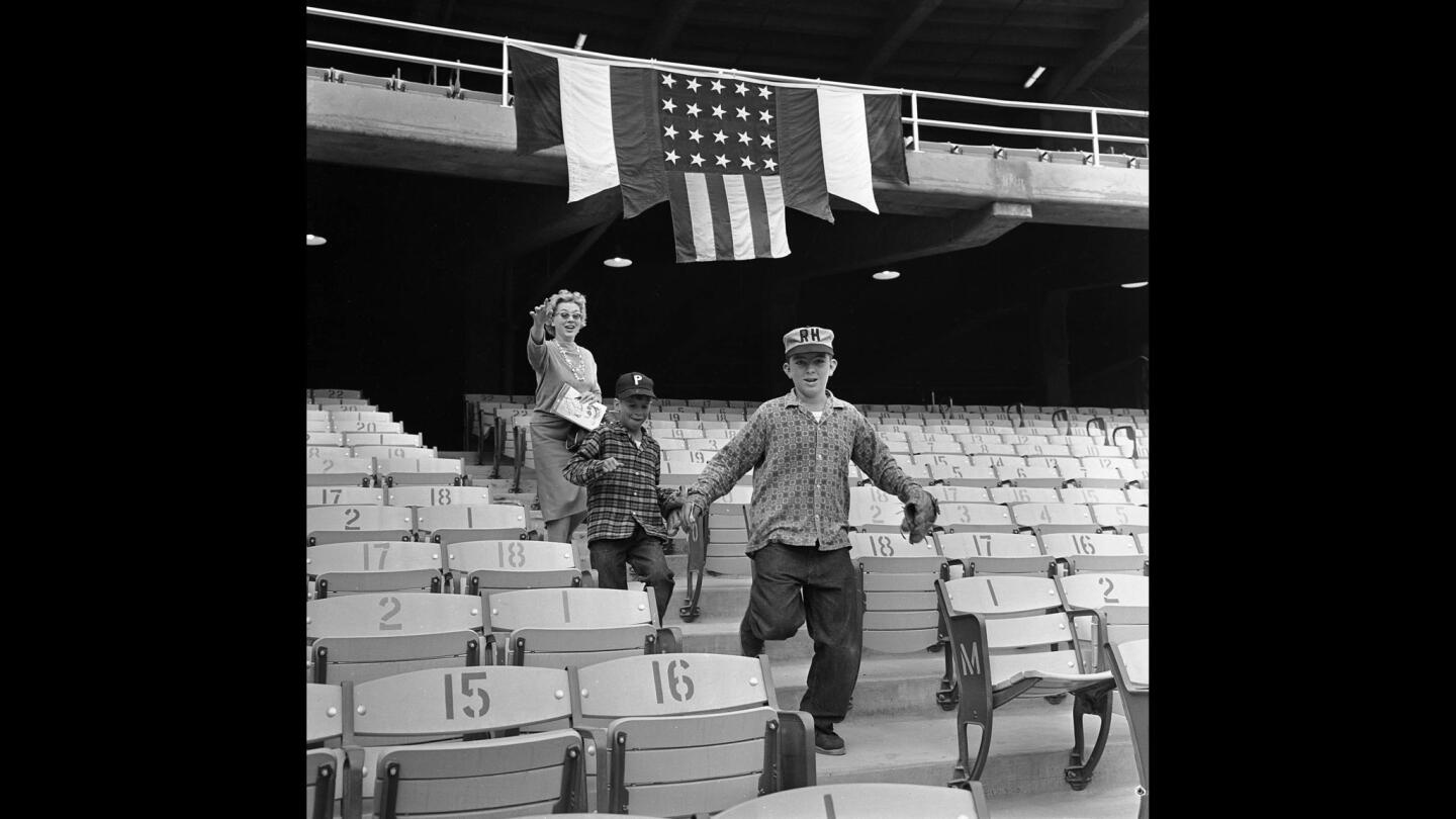 April 10, 1962: Racing for seats on opening day at Dodger Stadium are brothers Mike, 9, and Ricky, 11, followed by their mother, Dori Martin.