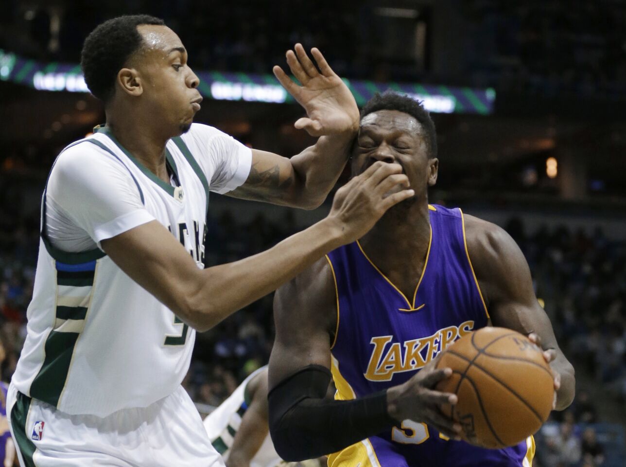 Lakers forward Julius Randle drives to the basket against Bucks center John Henson during the first half.