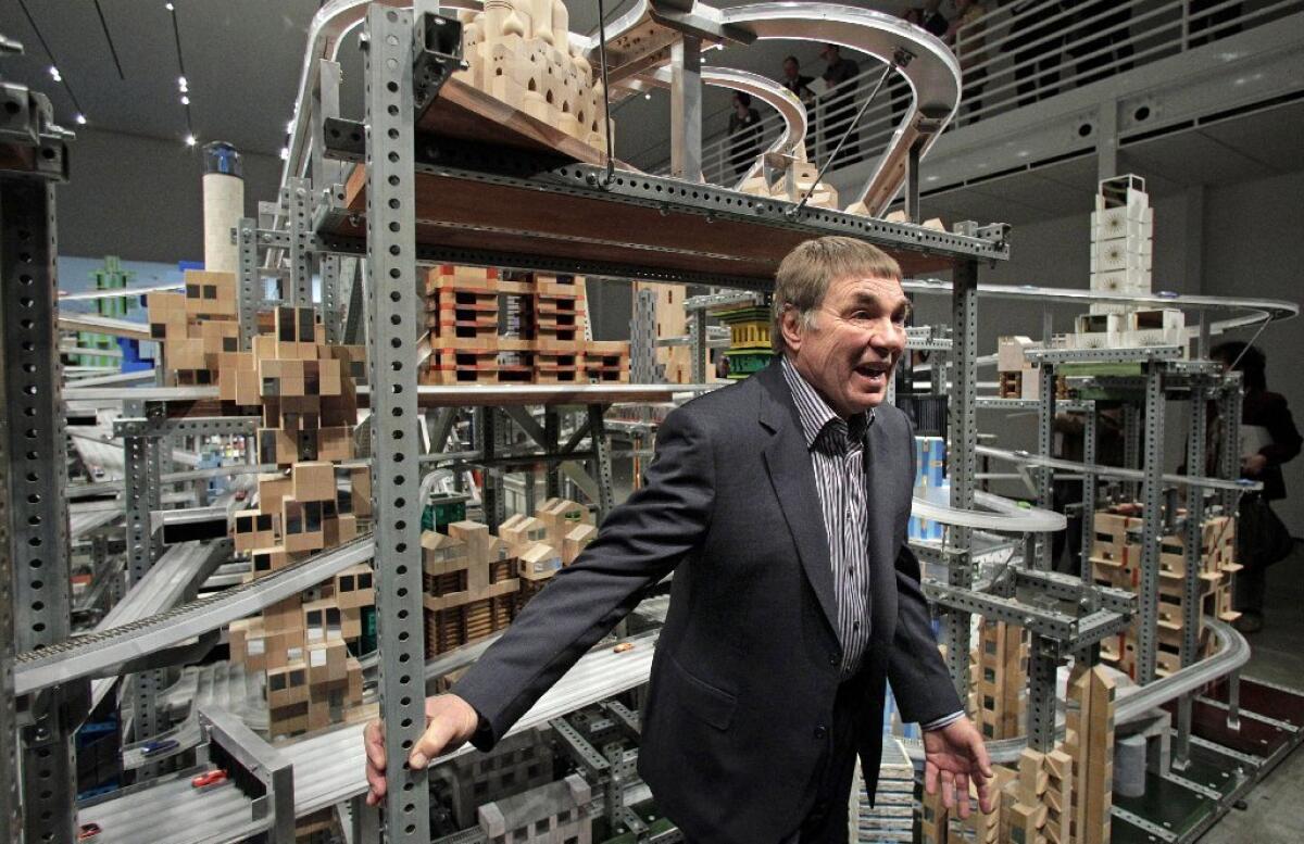 As a sculptor Chris Burden could be playful -- here he's posing in 2012 with his "Metropolis II" freeway-scape at the Los Angeles County Museum of Art. But he brought a dangerous edge to his early performance art piece, "TV Hijack."