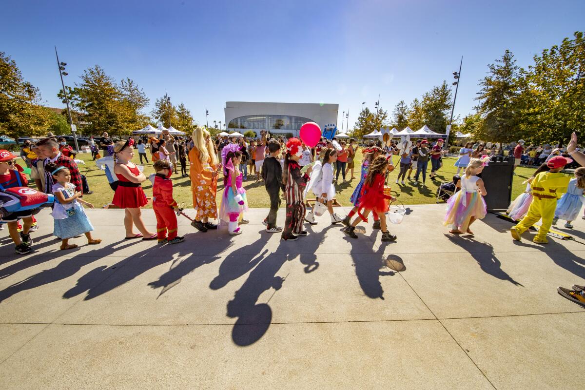 A children's costume parade at Lions Park in 2021 marches to the tune of Bobby "Boris" Pickett's "Monster Mash."