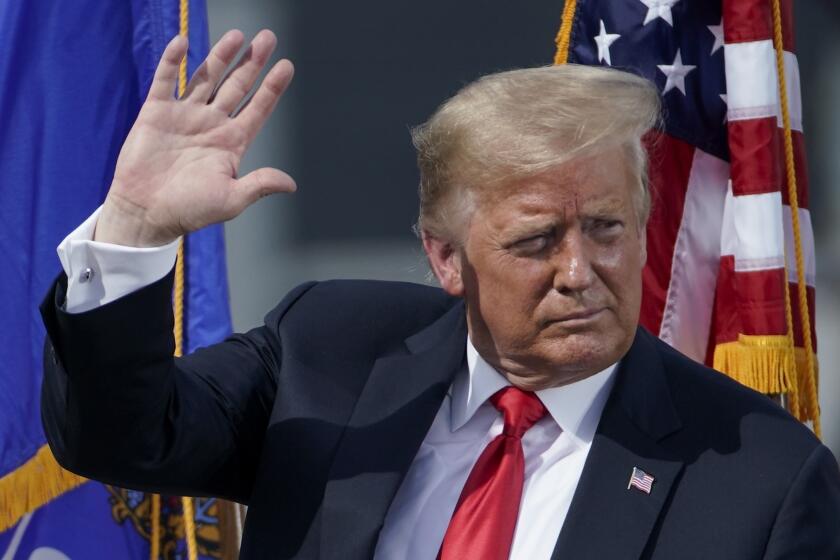 President Donald Trump leaves the stage after speaking at an event at Fincantieri Marinette Marine Thursday, June 25, 2020, in Marinette, Wis. (AP Photo/Morry Gash)
