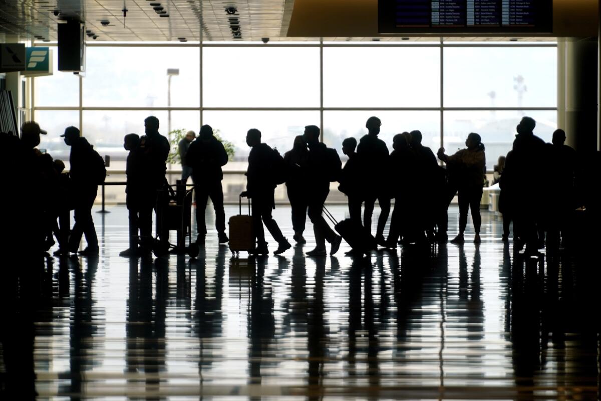 Travelers walk through the Salt Lake City International Airport