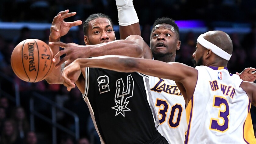 Spurs forward Kawhi Leonard has the ball knocked away by Lakers forward Corey Brewer.