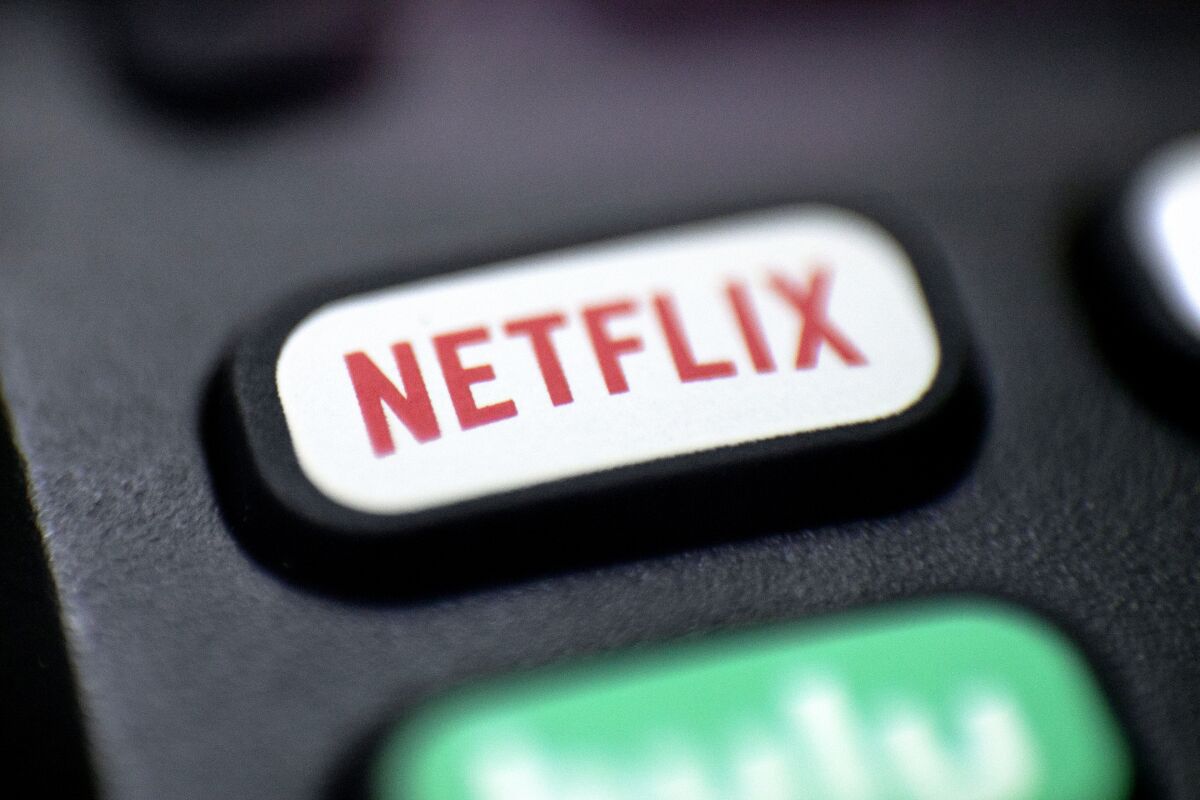 A close-up frame of a rounded rectangular button on a remote control that reads "Netflix" 